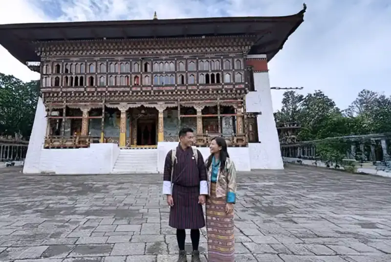 A couple in Bhutanese national dress outside a dzong