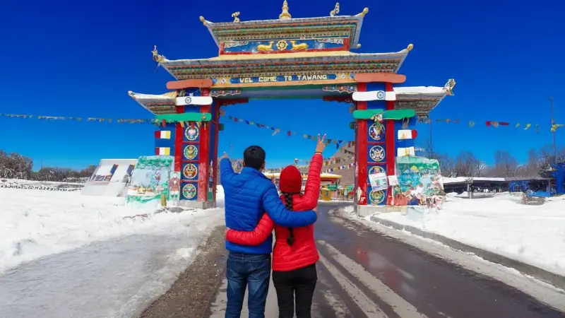 A couple at a snow-covered monastery gateway